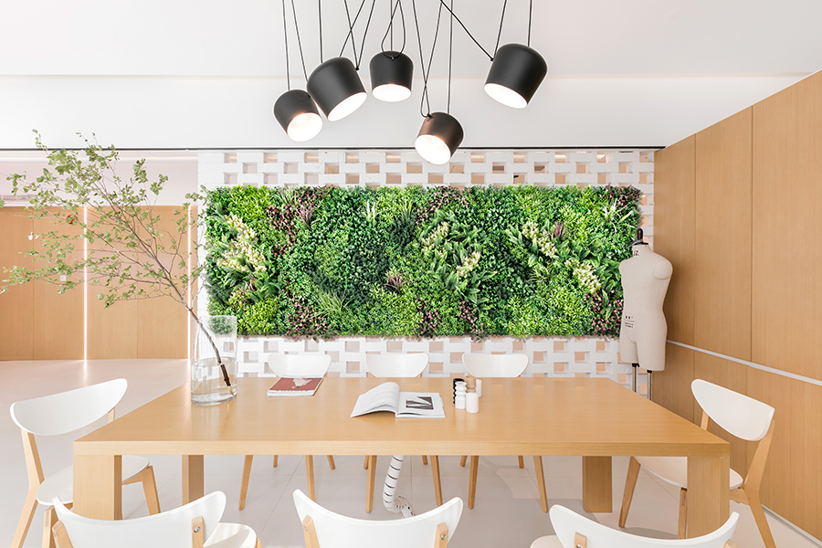 How to make artificial plants look real 3 a room with a table and chairs and a wall of plants